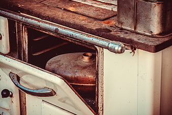 Rusty vintage stove with hot water bottle inside