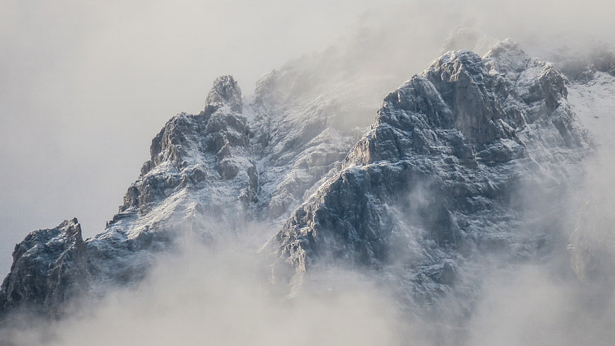 Majestic Snow-Capped Mountain Peak Shrouded in Mist
