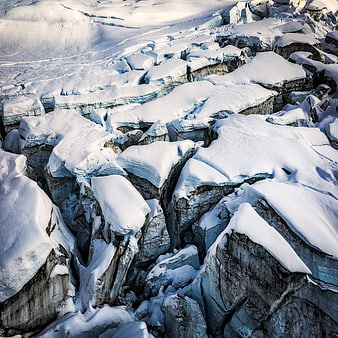 Aerial View of Fractured Snow-Covered Glacier Landscape