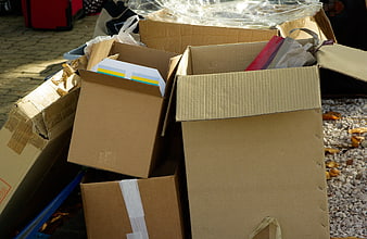 Stacked cardboard boxes with packaging materials and plastic wrap