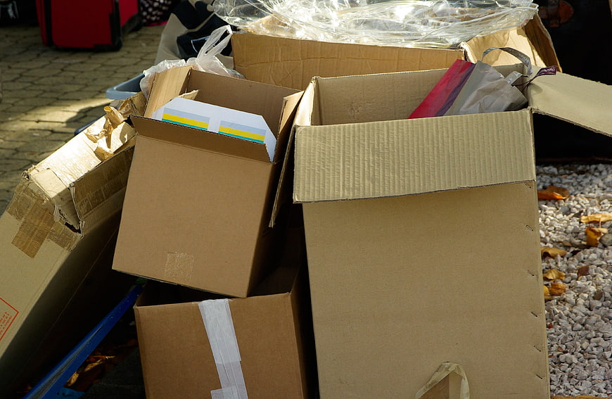 Stacked cardboard boxes with packaging materials and plastic wrap
