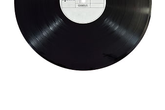 Close-up of black vinyl record with white label on white background