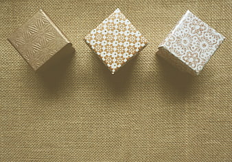 Three decorative gift boxes on burlap background