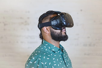 Man Wearing VR Headset in Green Shirt