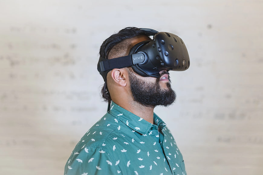 Man Wearing VR Headset in Green Shirt