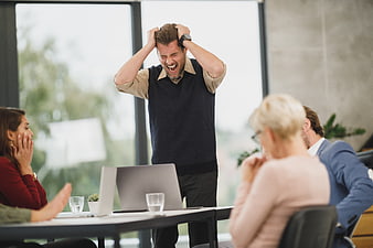 Angry Businessman Yelling at Team Meeting