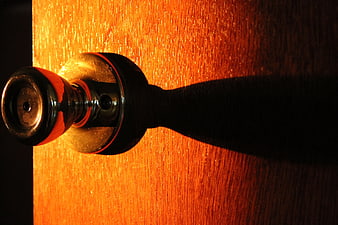 Close-up of vintage brass doorknob on wooden door