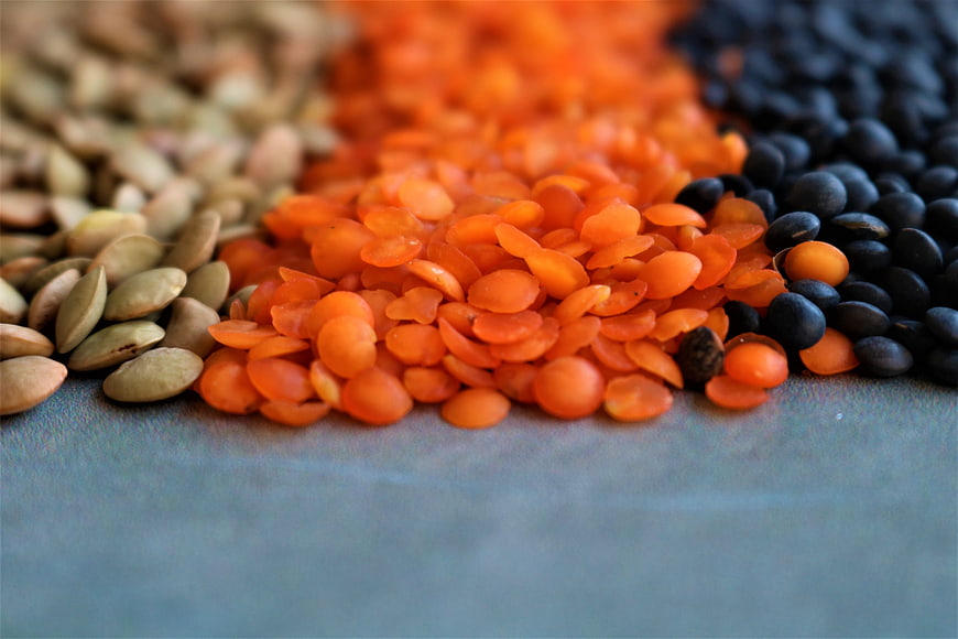 Close-up of Green, Red, and Black Lentils on Blue Surface