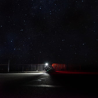 Bicycle with lights under starry night sky