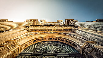 Low angle view of ornate classical architecture with columns and arch