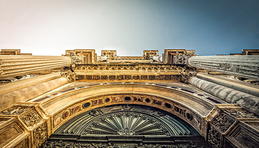 Low angle view of ornate classical architecture with columns and arch