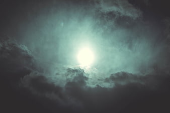 Dramatic Sunlight Breaking Through Dark Storm Clouds