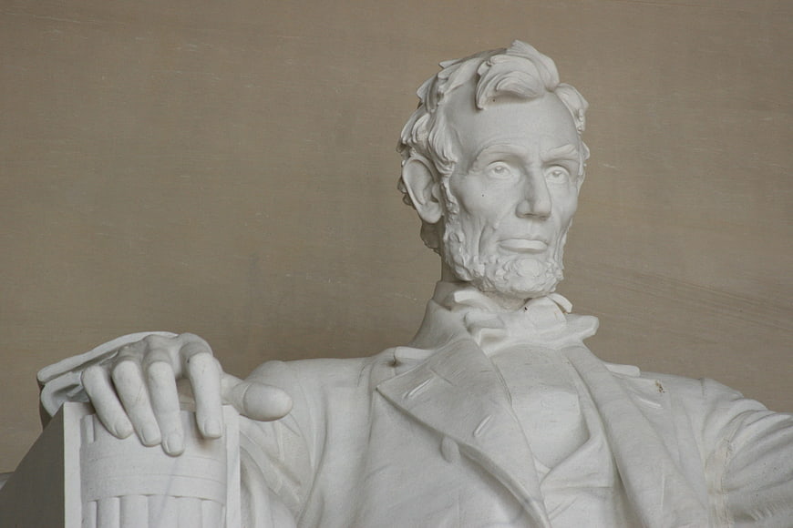 White marble bust of Abraham Lincoln with hand on architectural column