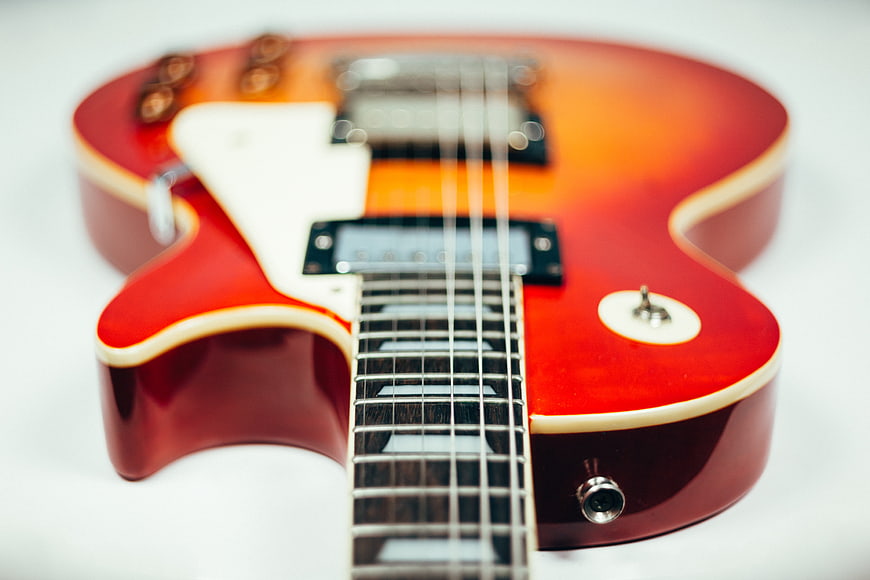 Close-up of a Red and Orange Sunburst Electric Guitar