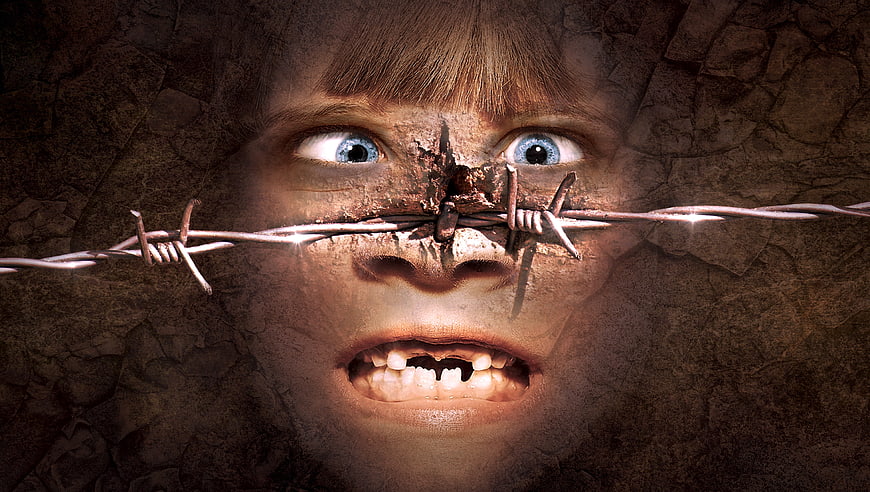 Surreal composite of child's face with barbed wire and cracked texture