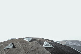 Modern Geometric Roof with Skylights Against White Sky