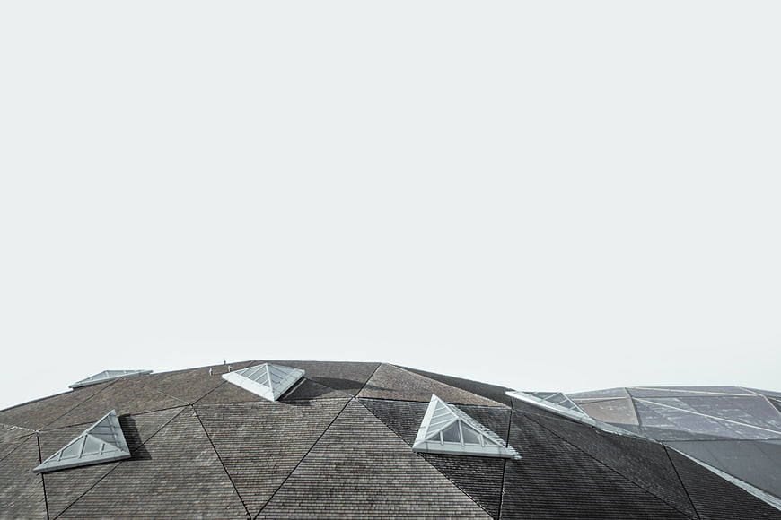 Modern Geometric Roof with Skylights Against White Sky