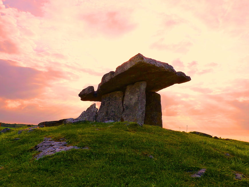 Ancient Dolmen Stone Structure on Green Hill at Sunset