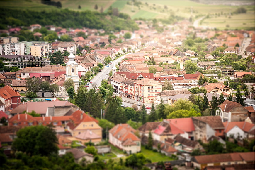 Aerial tilt-shift view of a European town with red roofs
