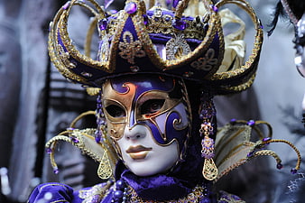 Close-up of ornate purple and gold Venetian carnival mask