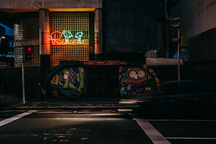 Neon Riviera sign and street art at night