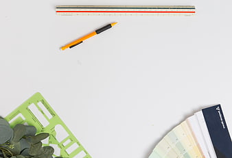 Top View of Design Tools and Color Swatches on White Background