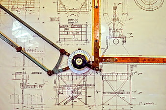 Vintage drafting tools on architectural blueprint