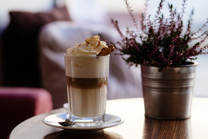 Layered Coffee Drink with Whipped Cream and Cookie Garnish