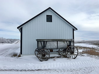 White Barn with Vintage Wagon in Snowy Winter Landscape