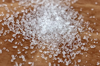 Coarse Sea Salt Crystals on Wooden Surface