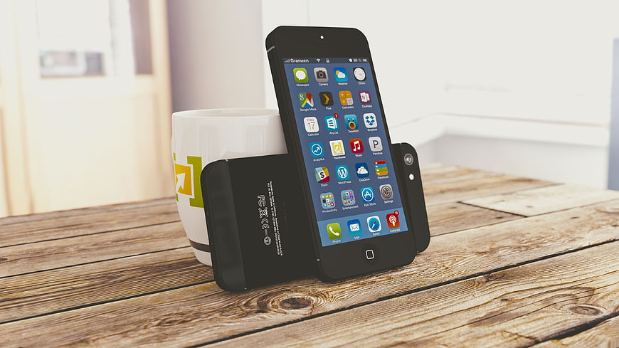 Black smartphones and coffee mug on rustic wooden table