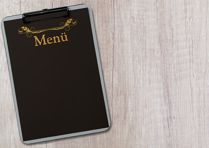Black Menu Clipboard on Wooden Table with Copy Space