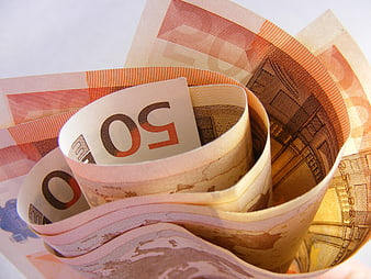 Close-up of rolled 50 Euro banknotes on white background