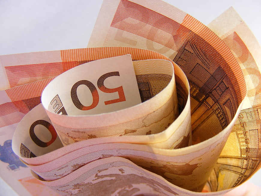 Close-up of rolled 50 Euro banknotes on white background