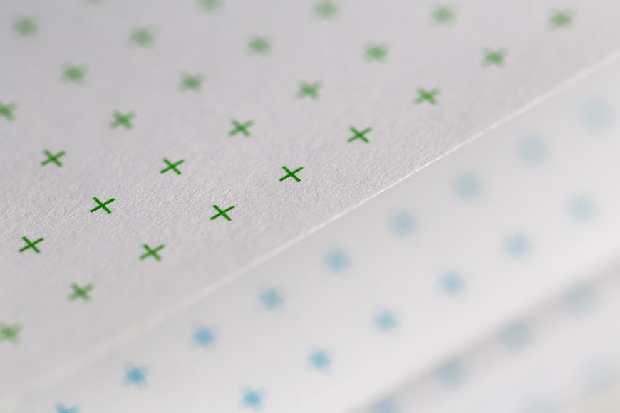 Close-up of Green Cross Pattern on Textured Paper