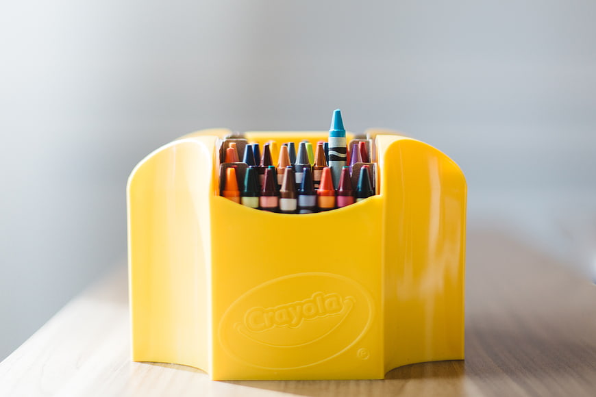 Yellow Crayola Crayon Holder on Wooden Table