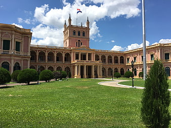 Palacio de los López in Asunción, Paraguay with manicured gardens and blue sky