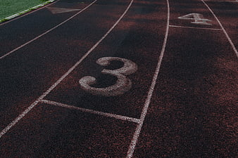 Close-up of Number 3 on Red Running Track Lane