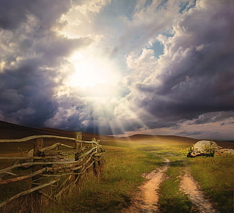 Dramatic Landscape with Sun Rays Breaking Through Storm Clouds