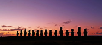 Panoramic Silhouette of Moai Statues at Sunset