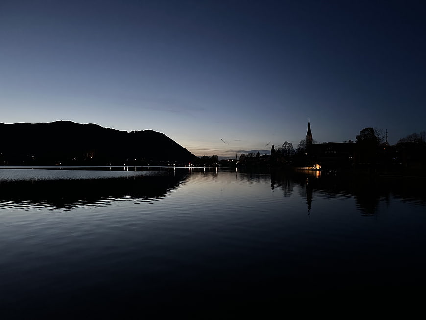 Serene Lake Landscape at Dusk with Church Silhouette and Reflections