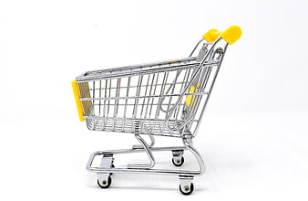 Miniature metal shopping cart with yellow handles on white background