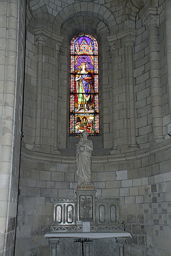 Stained Glass Window and Statue in Gothic Church Interior