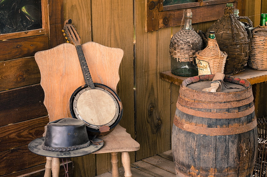 Vintage Western Props: Banjo, Cowboy Hat, and Barrel