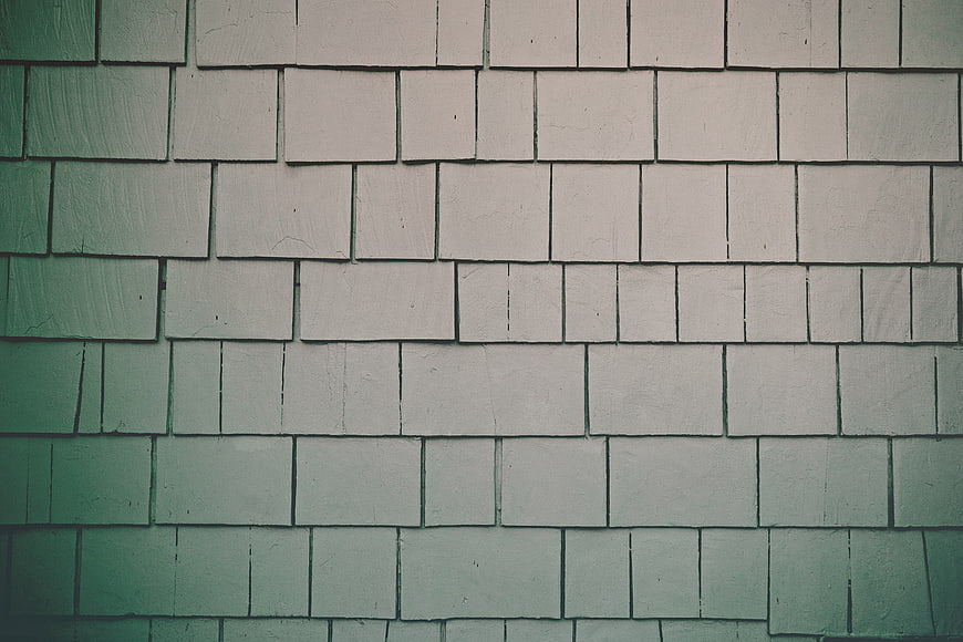 Textured Green and White Brick Wall Background