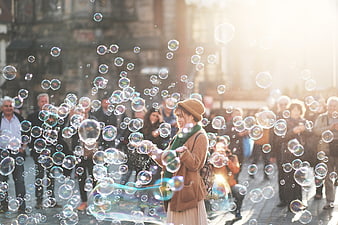 Woman Making Bubbles in Crowded Street