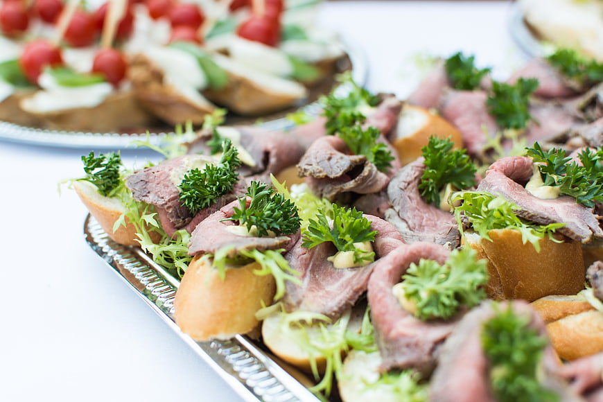 Close-up of roast beef canapés with parsley garnish