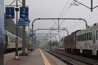 Korean Train Station Platform with Trains on Foggy Day