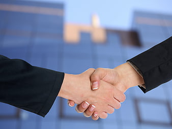 Business Handshake Against Blurred Corporate Glass Building Background
