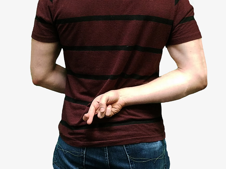 Man with hands behind back in maroon striped t-shirt